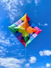 A colorful kite flying in a blue sky. Generative AI.