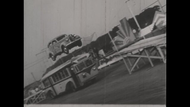 United Kingdom 1950, Daredevil Jump: Stuntman Leaps Over Bus with Vintage Car in the 1950s