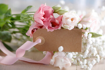 Fresh bouquet and a blank paper tag with ribbon