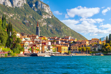 The skyline and beach of the colorful Italian lakefront resort village of Varenna, Italy at summer...
