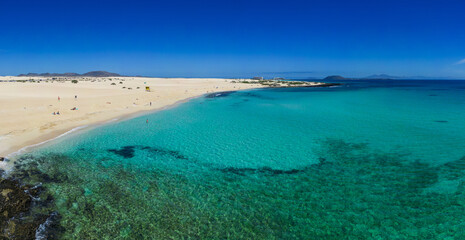 Beautiful mid level aspect aerial panoramic view of Grandes Playa beach with clear turquoise water near Corralejo in Fuerteventura Spain