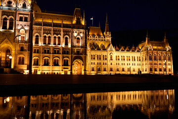A fabulous nighttime photo of the illuminated facade of the parliament building in Budapest, reflected in the water
