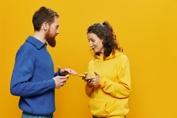 Woman man cheerful couple with phones in hand social networking and communication crooked smile fun...