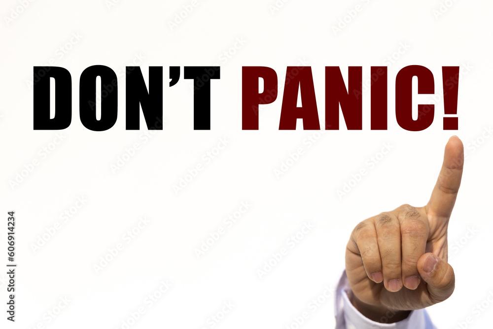 Poster don't panic text on white wall background with businessman's finger point at the message with empty 