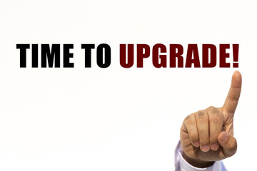 Time to upgrade text on white wall background with businessman's finger point at the message with empty space. This message can be used as business concept about time to upgrade.