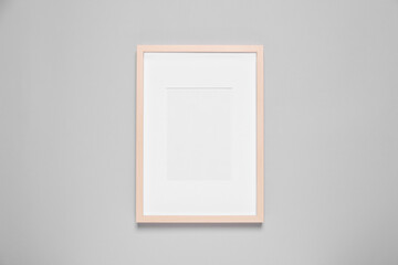 Empty photo frame on light background, top view. Space for design