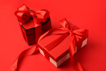 Beautiful gift boxes with bows on red background