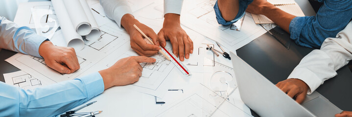 Architect or engineer working on building blueprint, contractor designing and drawing blueprint...