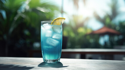 A glass with an exotic blue cocktail on a bungalow poolside table. Summer refreshing drinks with ice Generative AI