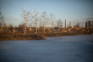 Fototapeta na wymiar View of lake. Landscape with plant. Ice on lake.