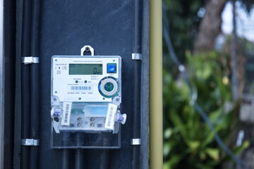 Digital electricity meter on pole. Electric meter showing energy consumption in high precision...