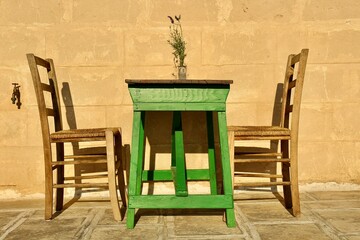 Green table with two chairs