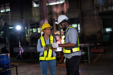 The engineer consult manager looks at the digital tablet checking maintenance part for outage
