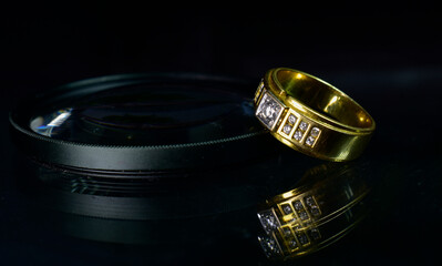 The wedding ring is a gold ring decorated with diamonds.