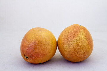 Two fresh and ripe grapefruits isolated on a clear background with copy space