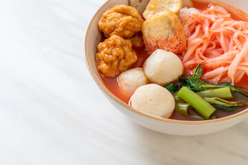 small flat rice noodles with fish balls and shrimp balls in pink soup, Yen Ta Four or Yen Ta Fo