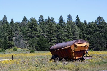 Naklejka premium old farm trailer in the field