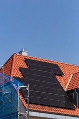 solar panel on building roof with construction scaffold