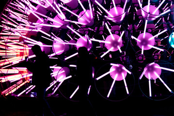 people dancing in front of light