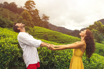 Couple of Travelers in Love in Front of Tea Plantations in Mountains - obrazy, fototapety, plakaty