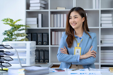 Portrait of young beautiful Asian businesswoman in the office. Crossed arms. Successful Asia business woman confident smiling.