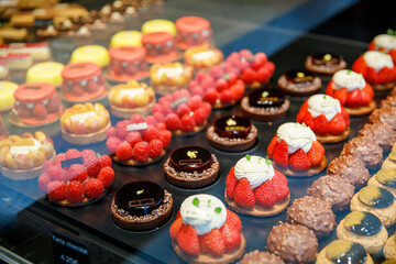 French pastries on display in store window of cafe or bakery.