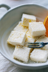 Orange milk pastry, baked pastries, fresh oranges and milk pastry on the table