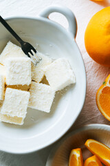 Orange milk pastry, baked pastries, fresh oranges and milk pastry on the table