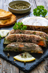 Turkey meat in jelly wooden table
