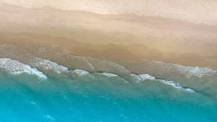 Aerial view with beach in wave of turquoise sea water shot, Top view of beautiful white sand background