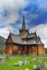 Fototapeta na wymiar stavkirke typical stave church of Borgund in Norway, with cemetery with gravestone in front