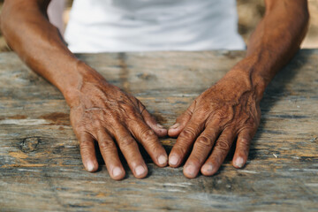 Male wrinkled hands, old man is wearing.