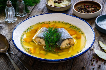 Fish soup on wooden table
