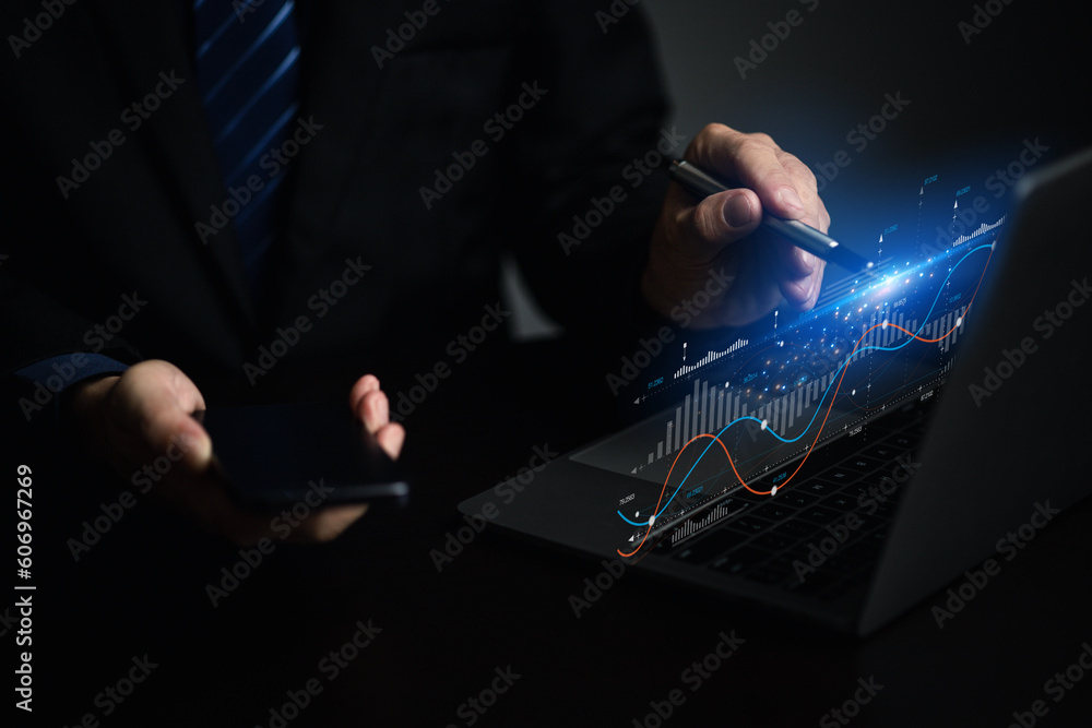 Fototapete businessman working with holograms showing business graphs and various information in work, using te