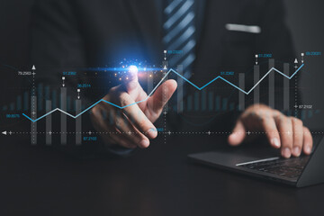 Businessman working with holograms showing business graphs and various information in work, using technology in business management for efficient work and modern business operations.