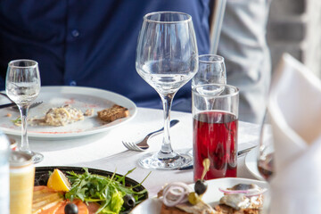 Restaurant table set with wine glasses and snacks
