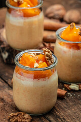 Pumpkin parfait with whipped cream, nuts in glass. Delicious breakfast or snack