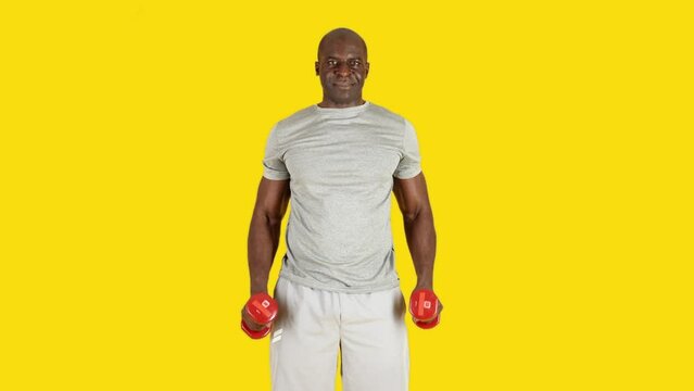 African man standing doing curl bicep exercise with dumbbells