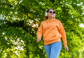 Beautiful woman walking in city park
