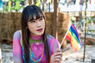 Gender Spectrum smiling happy Thai transgender Asian woman with rainbow flag