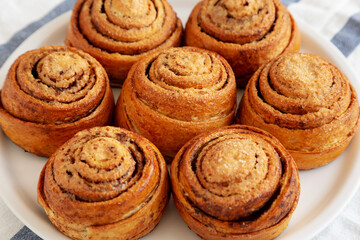 Homemade Cinnamon Roll Pastry on a white wooden background, side view. Close-up.
