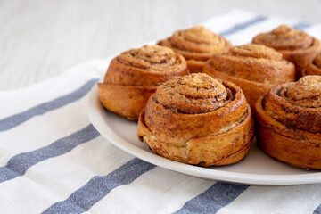 Homemade Cinnamon Roll Pastry on a white wooden background, low angle view. Close-up.