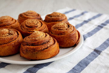 Homemade Cinnamon Roll Pastry on a white wooden background, low angle view. Close-up.
