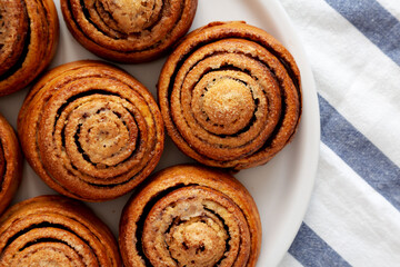 Homemade Cinnamon Roll Pastry on a white wooden background, top view. Flat lay, overhead, from above. Close-up.