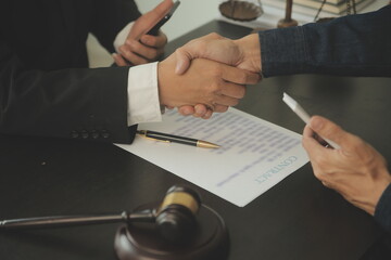 Business and lawyers discussing contract papers with brass scale on desk in office. Law, legal...