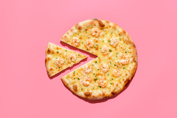 Homemade shrimp pizza isolated on a pink background. Sliced pizza top view