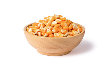 Dry corn seeds (raw popcorn grains) in wooden bowl isolated on white background with clipping path.