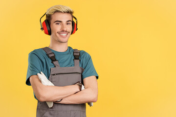 Friendly gay carpenter smiling at camera in work uniform