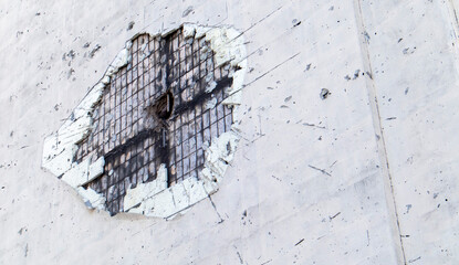 Traces of an artillery shell hitting a multi-storey residential building. Part of the building was...