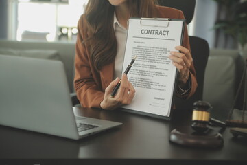 Business and lawyers discussing contract papers with brass scale on desk in office. Law, legal...